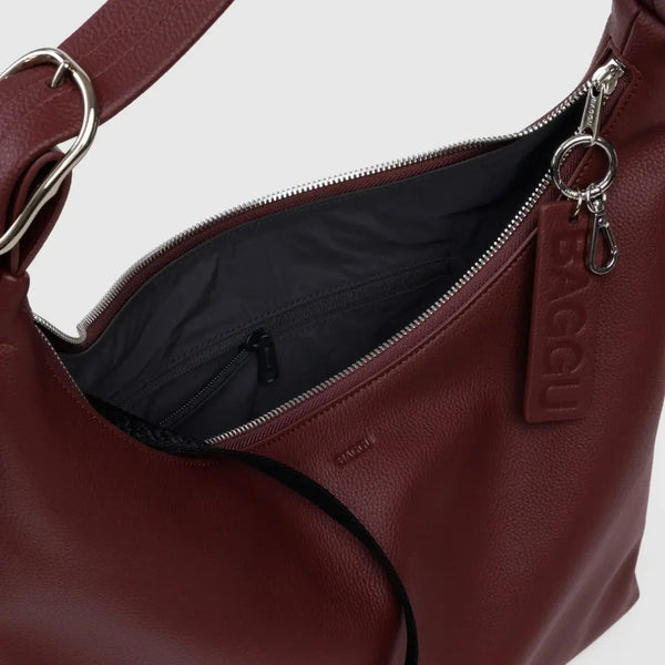Brown leather handbag with visible brand logo on a white background