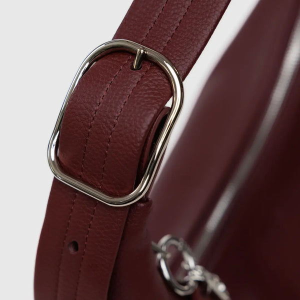 Silver Hardware and buckle on a mahogany leather bag strap