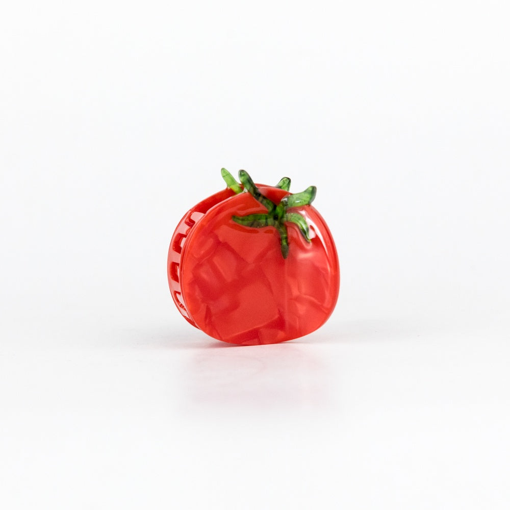 Red tomato-shaped hair claw on a white background