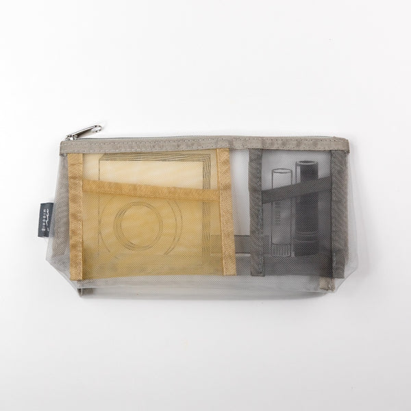 Clear pouch with mesh side showing wooden block and other items on a white background