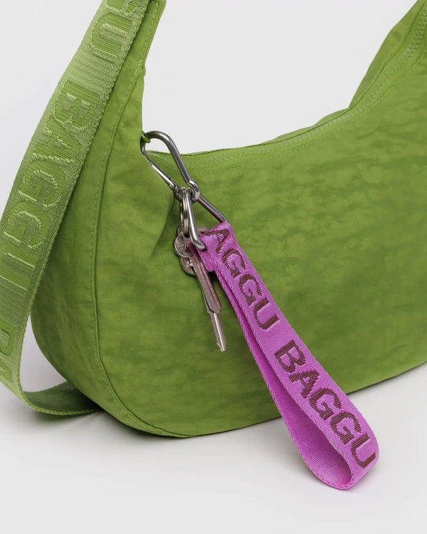 Green bag with a pink 'BAGGU' keychain on a white background