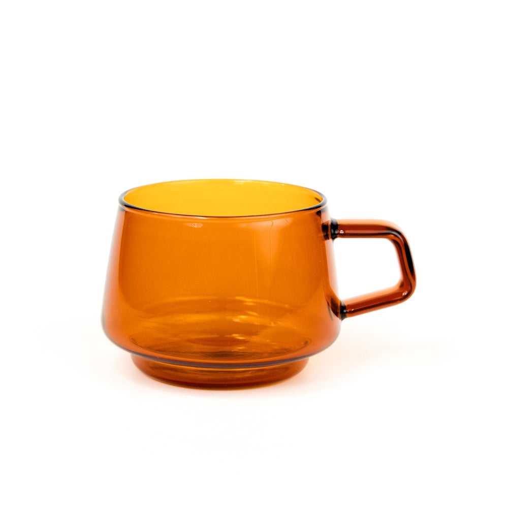 Orange glass mug on a white background