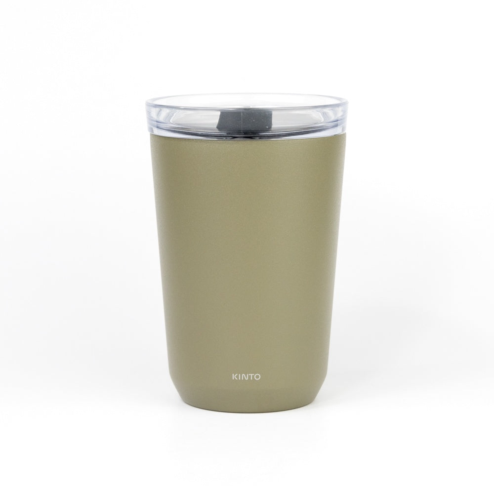 Green tumbler with a clear lid on a white background