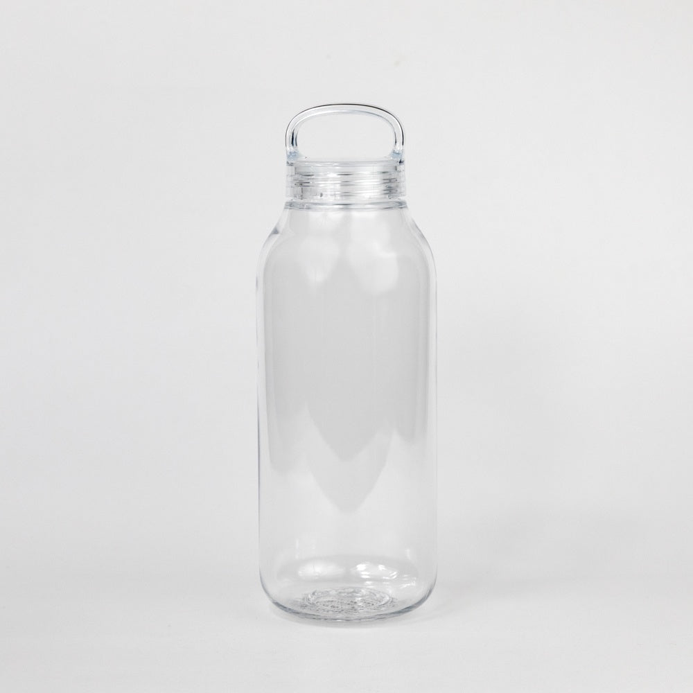 Clear glass water bottle with a cap on a white background