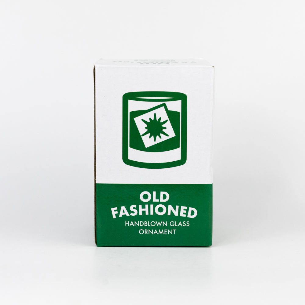 Box for an old-fashioned handblown glass ornament with green and white design.