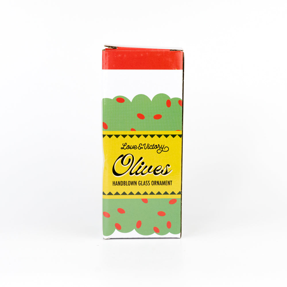 Ornament shaped like a jar of olives hanging on a Christmas tree branch.