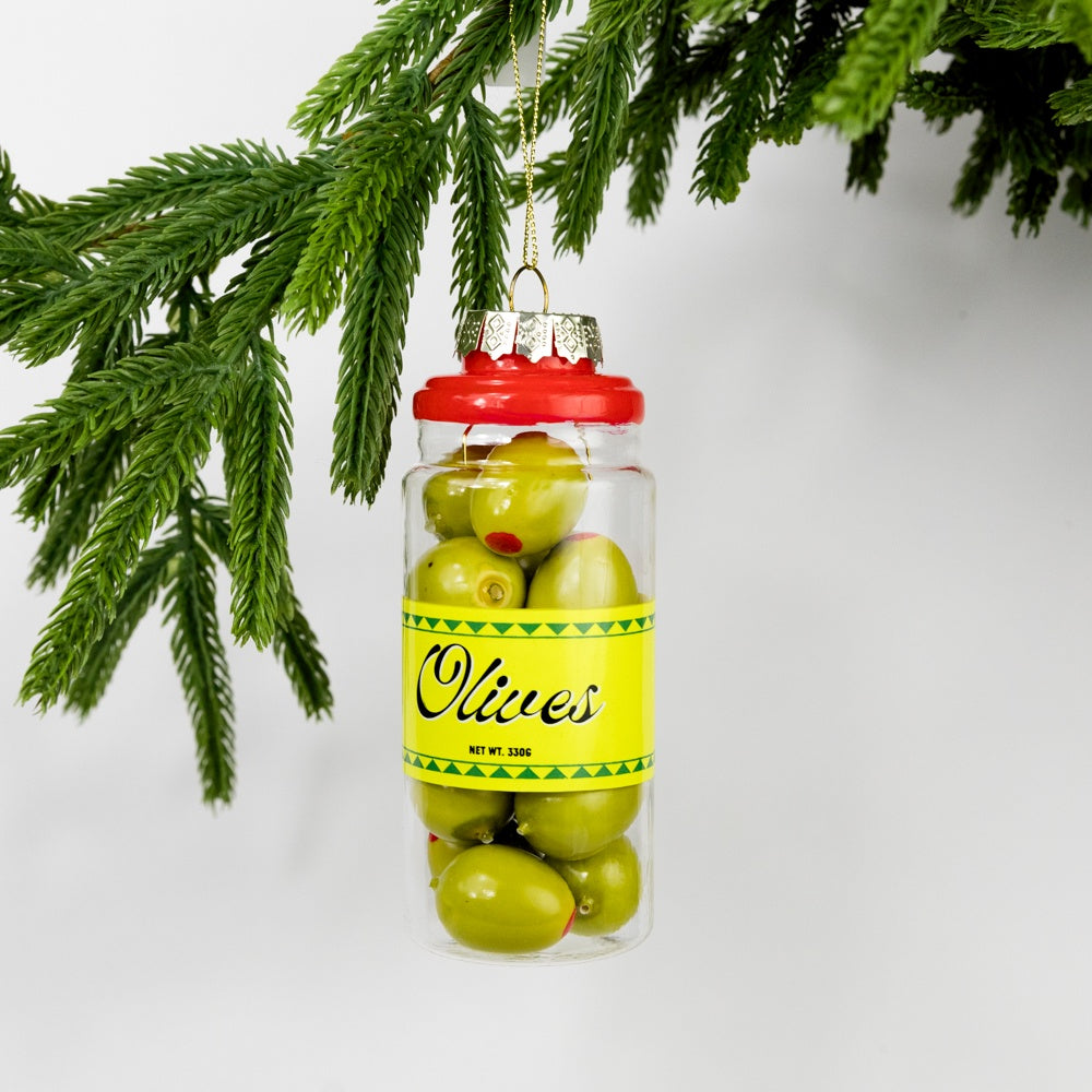 Ornament shaped like a jar of olives hanging on a Christmas tree branch.