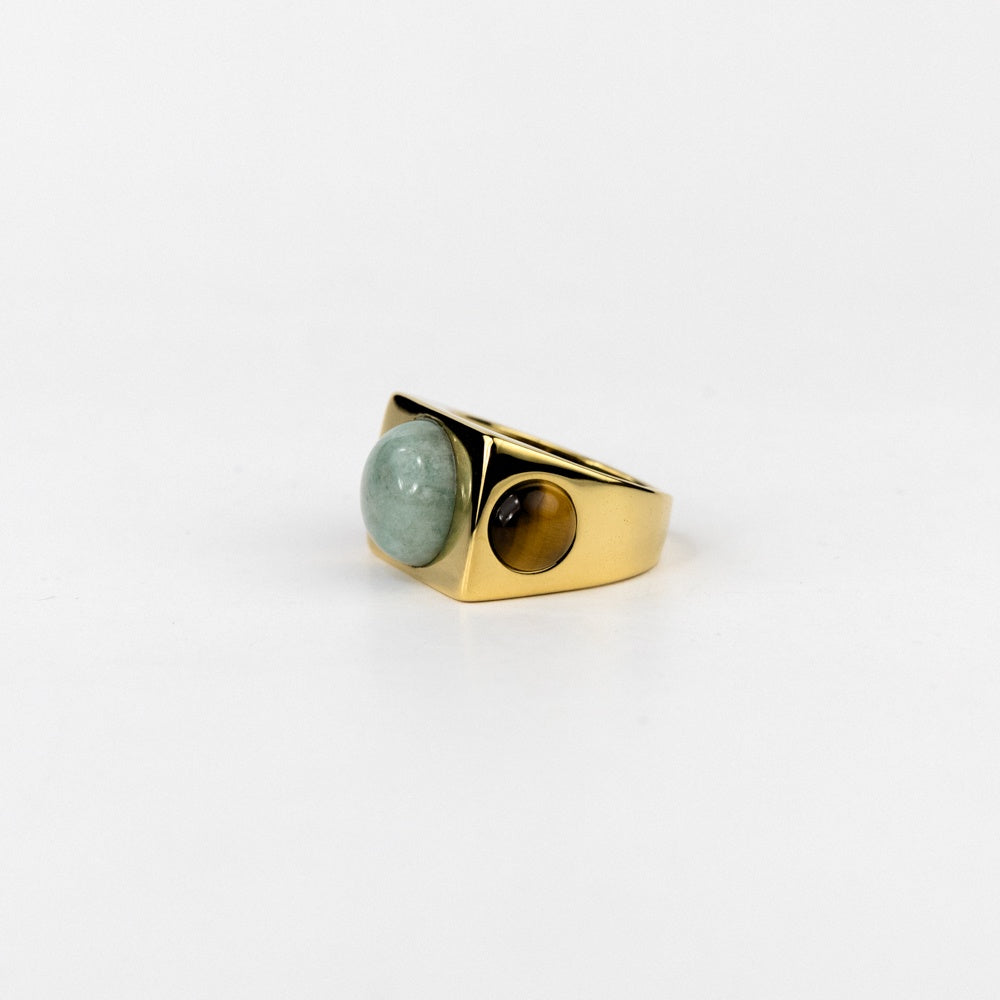 Gold ring with gemstones on a white background