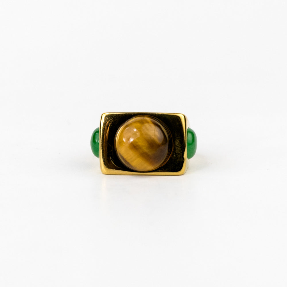 Ring with a tiger's eye stone and green accents on a white background