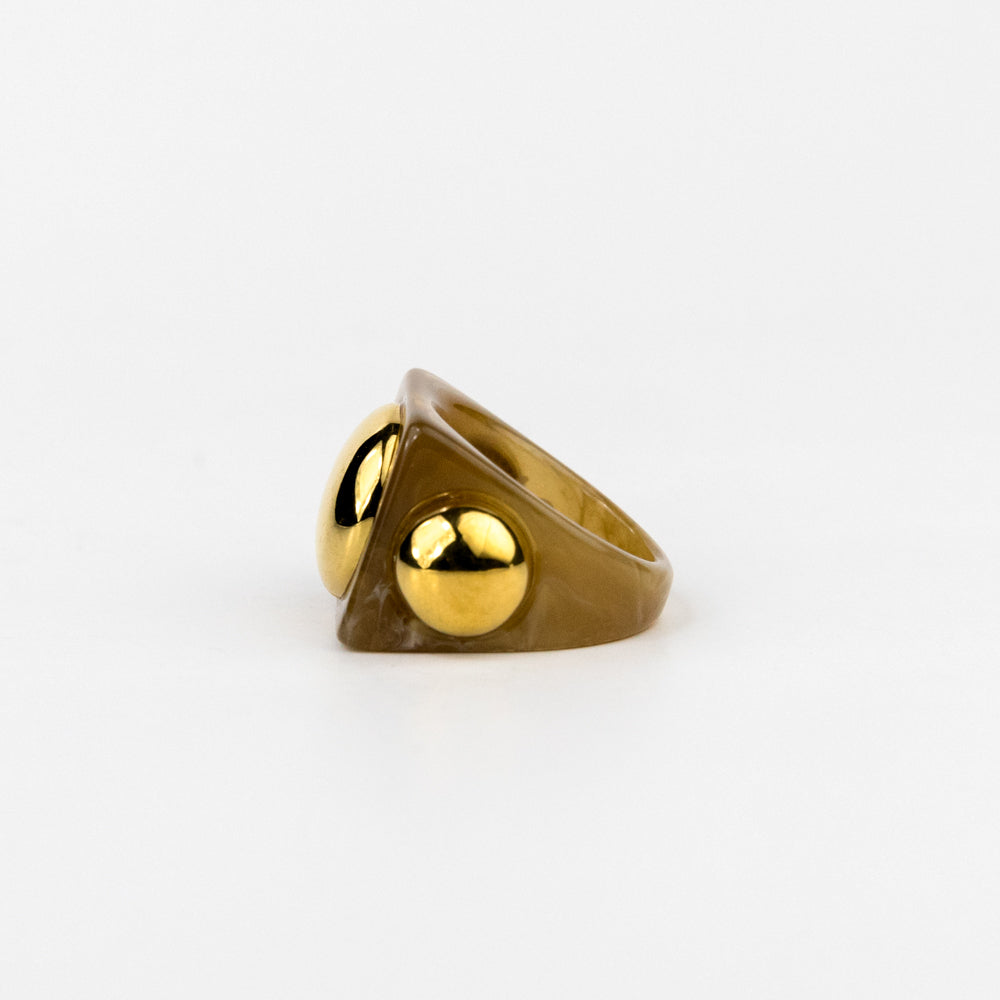 Gold ring with a unique design on a white background
