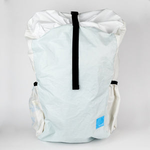 Light blue backpack with a black strap on a white background