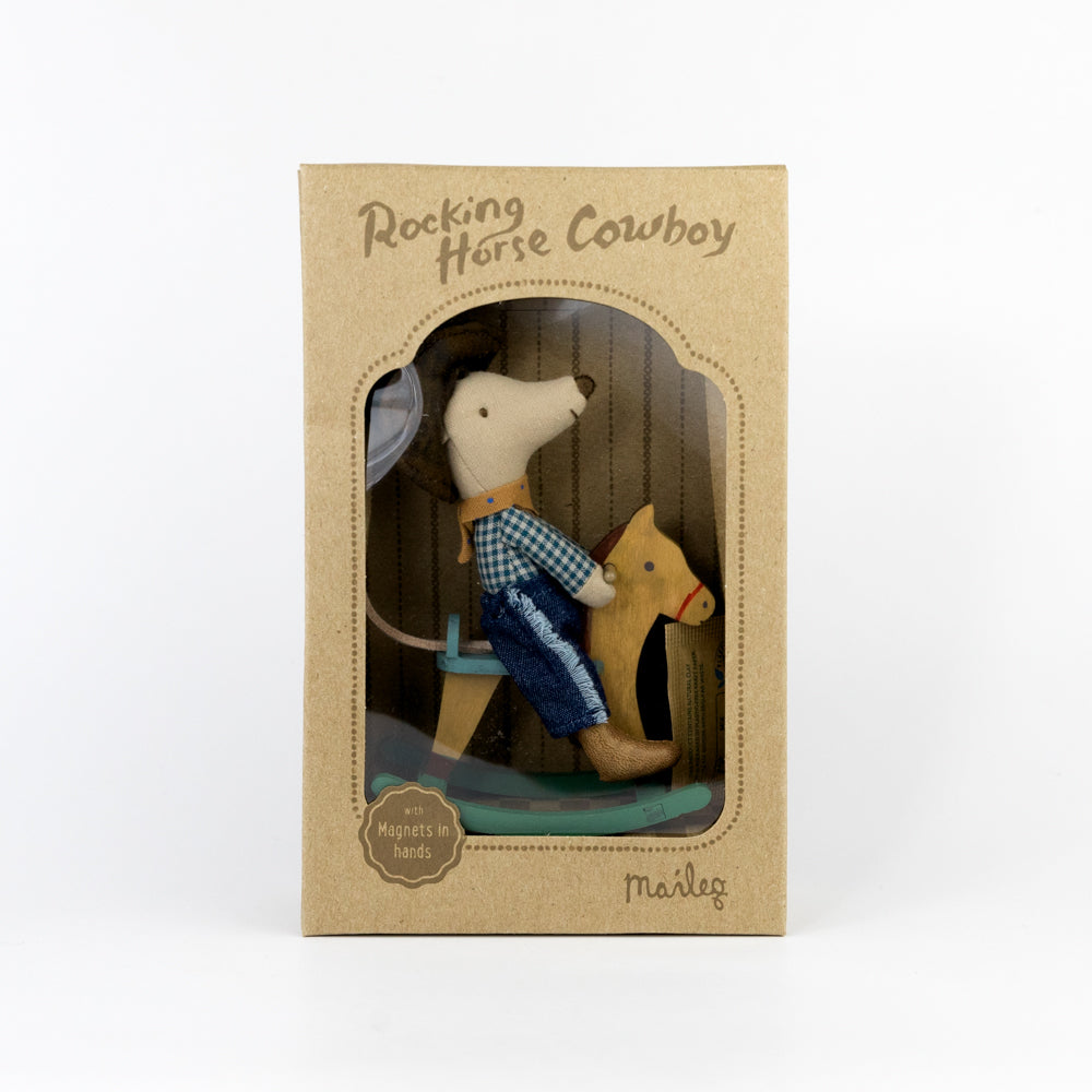 Toy mouse in a cowboy outfit riding a rocking horse inside a cardboard box with 'Rocking Horse Cowboy' text.