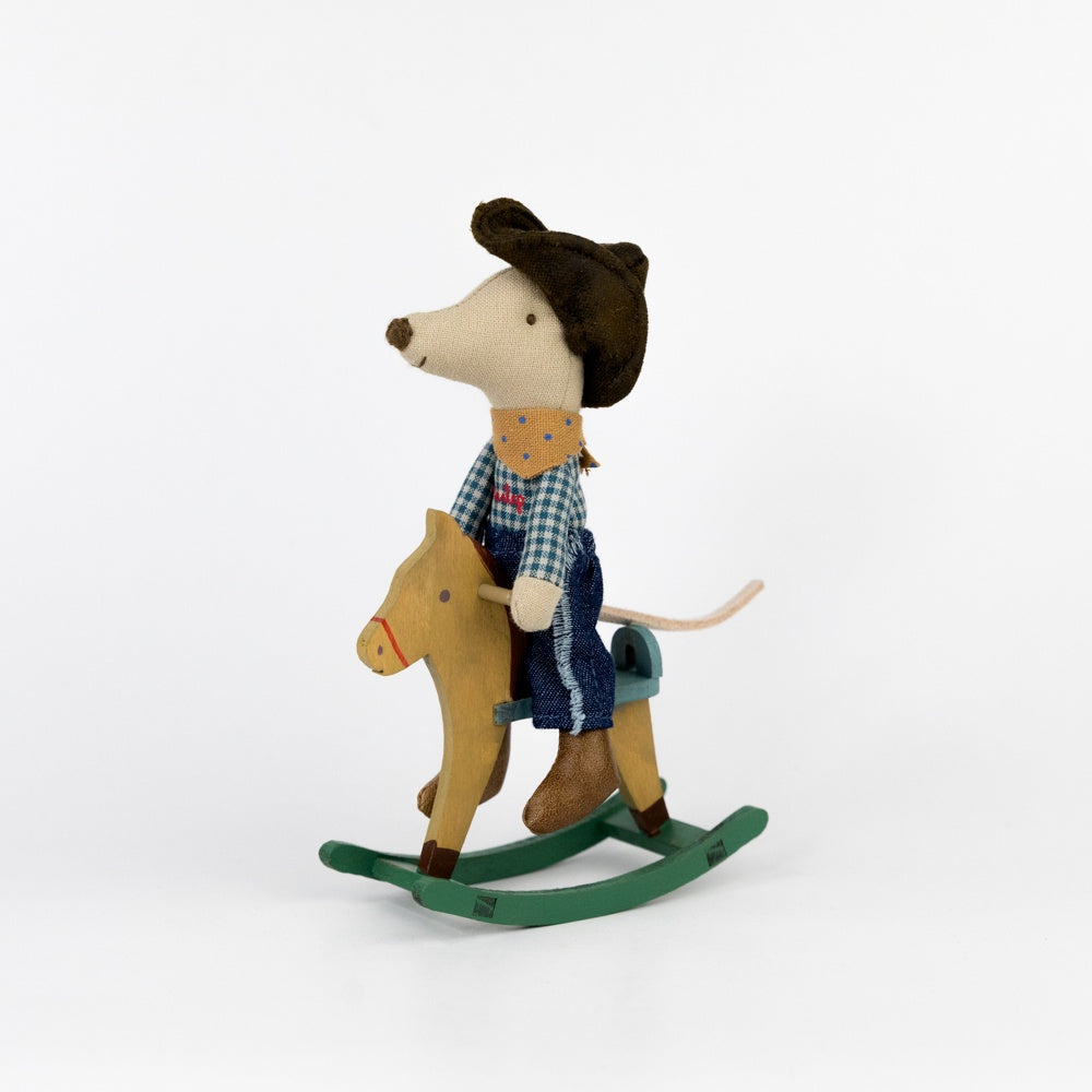 Toy mouse in a cowboy outfit riding a rocking horse on a white background
