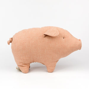 Pink checkered pig-shaped pillow on a white background