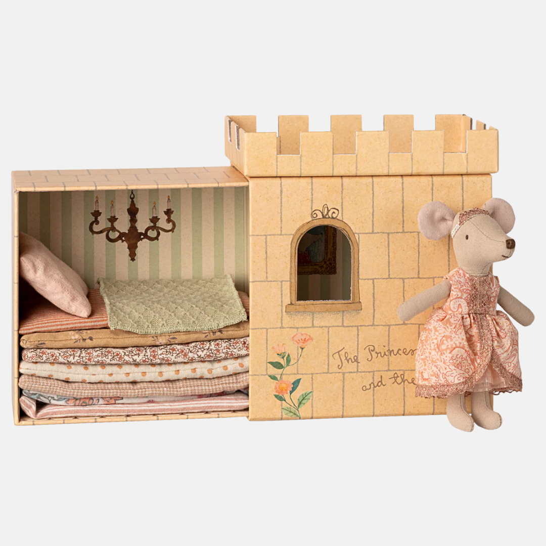 Wooden castle toy with a plush mouse toy in a dress on a white background