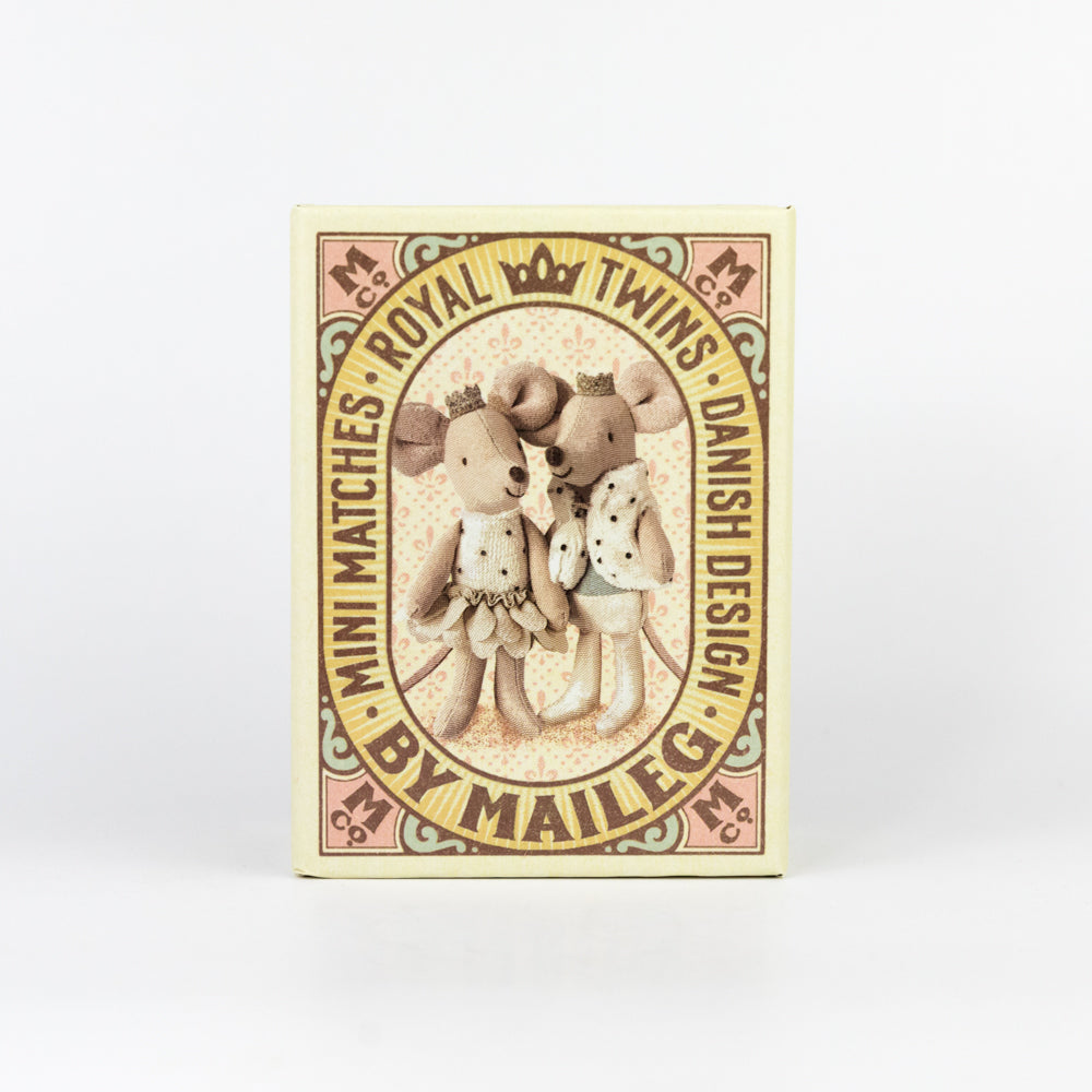 Two stuffed animal mice in a decorative box on a white background