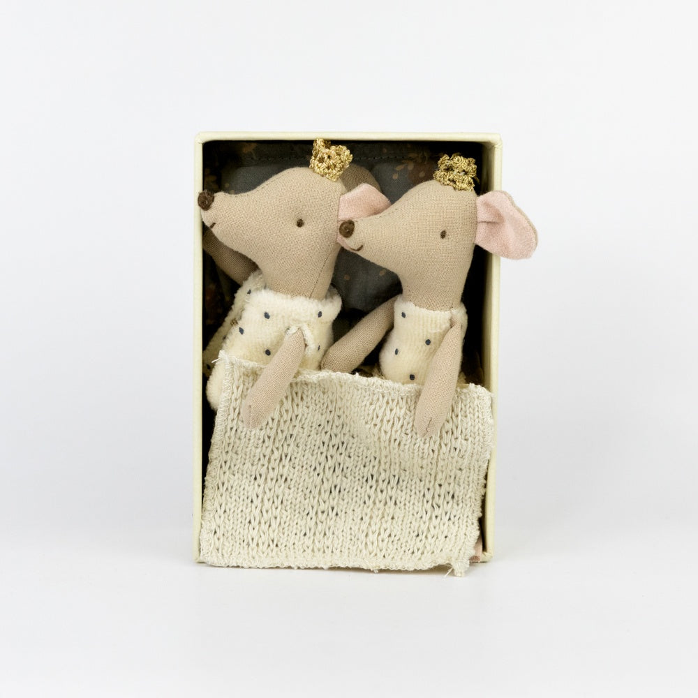 Two stuffed animal mice in a decorative box on a white background