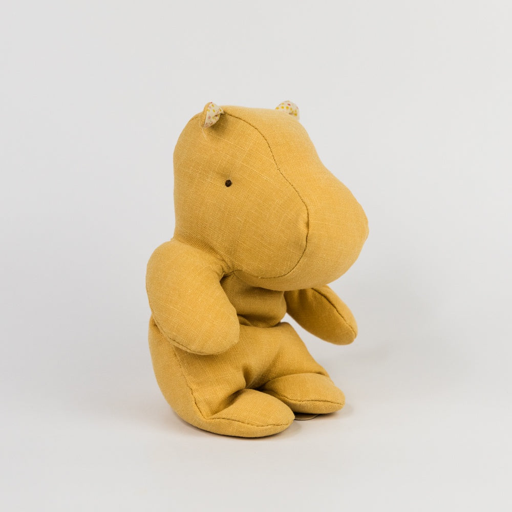 Yellow plush hippo toy on a white background