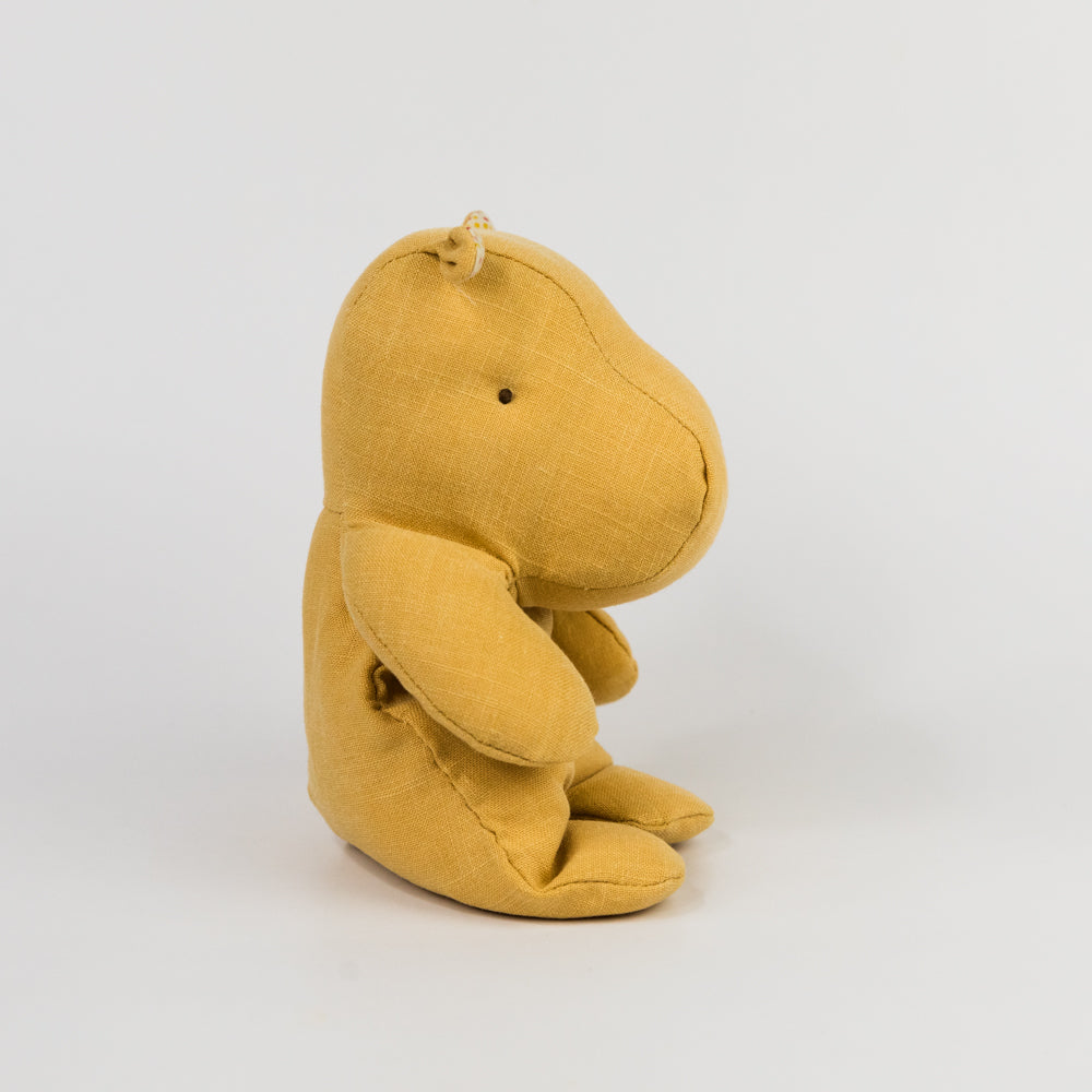 Yellow plush hippo toy on a white background