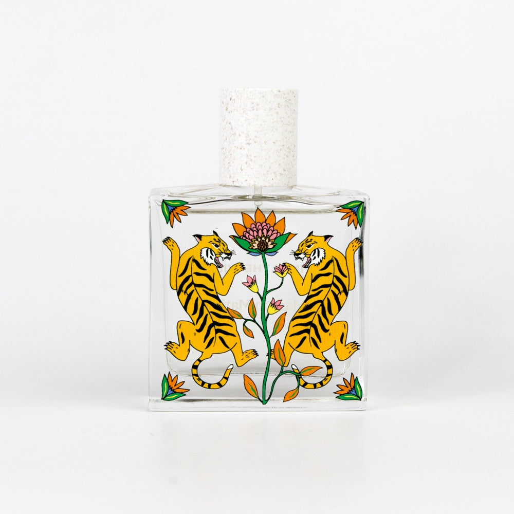 Perfume bottle with tiger design on a white background