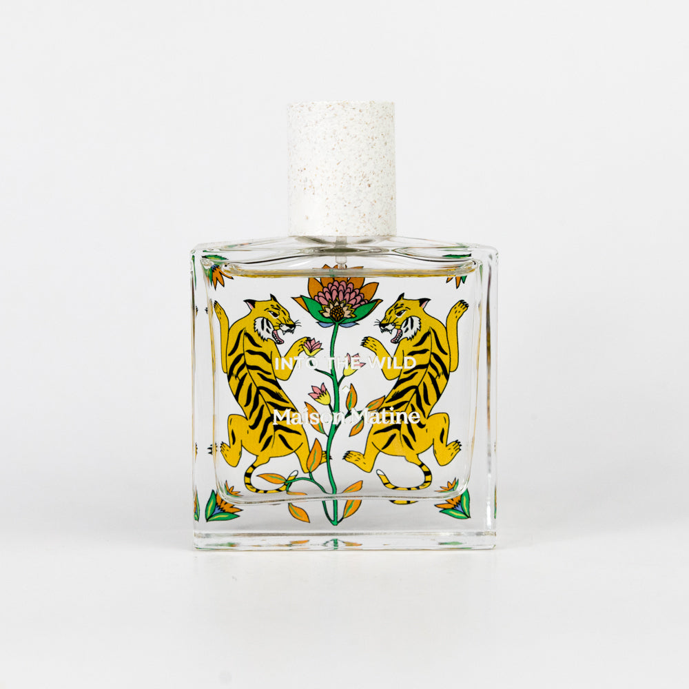 Perfume bottle with tiger design on a white background