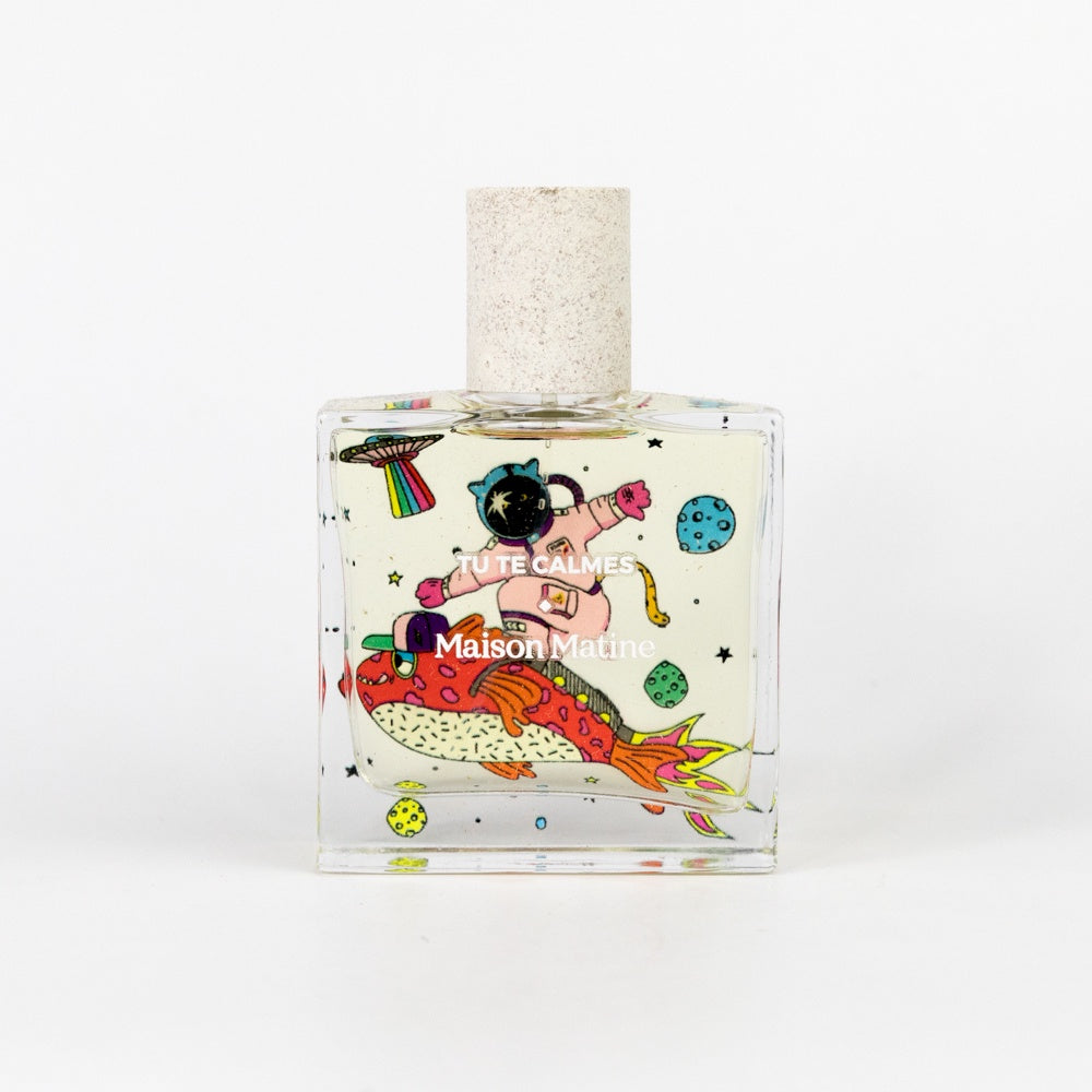 Perfume bottle with colorful design and 'Maison Martine' branding on a white background