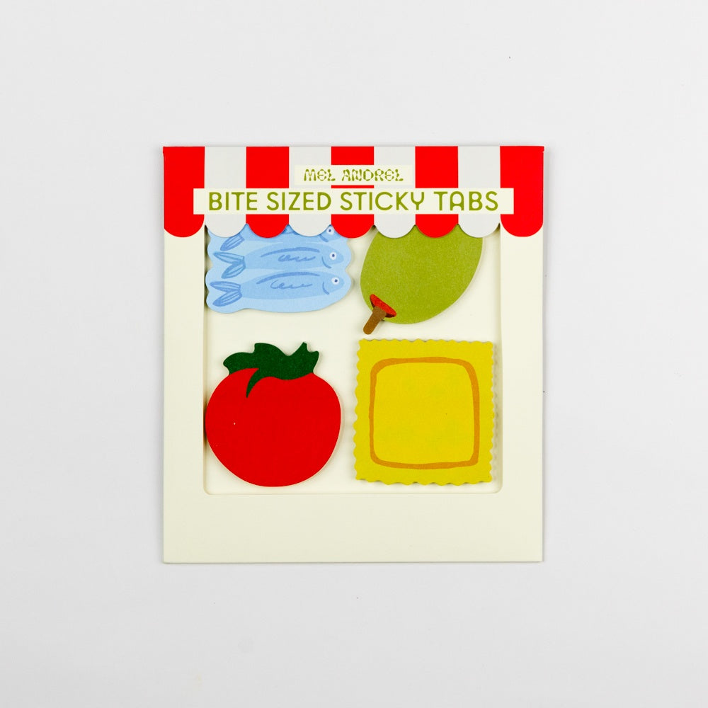 Bite-sized sticky tabs with colorful designs in a packaging box on a light gray background