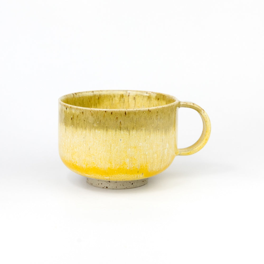 Yellow ceramic mug on a white background