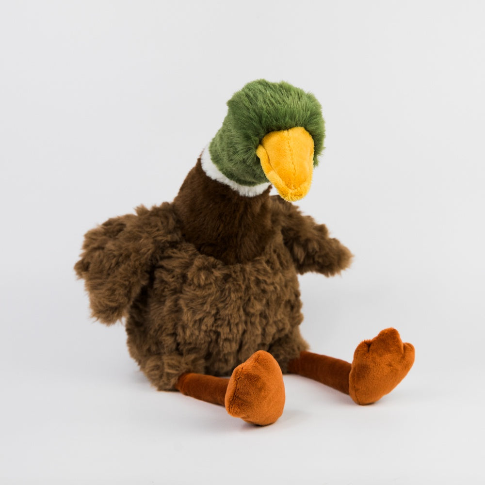 Plush toy resembling a duckwith a green head and brown body on a white background