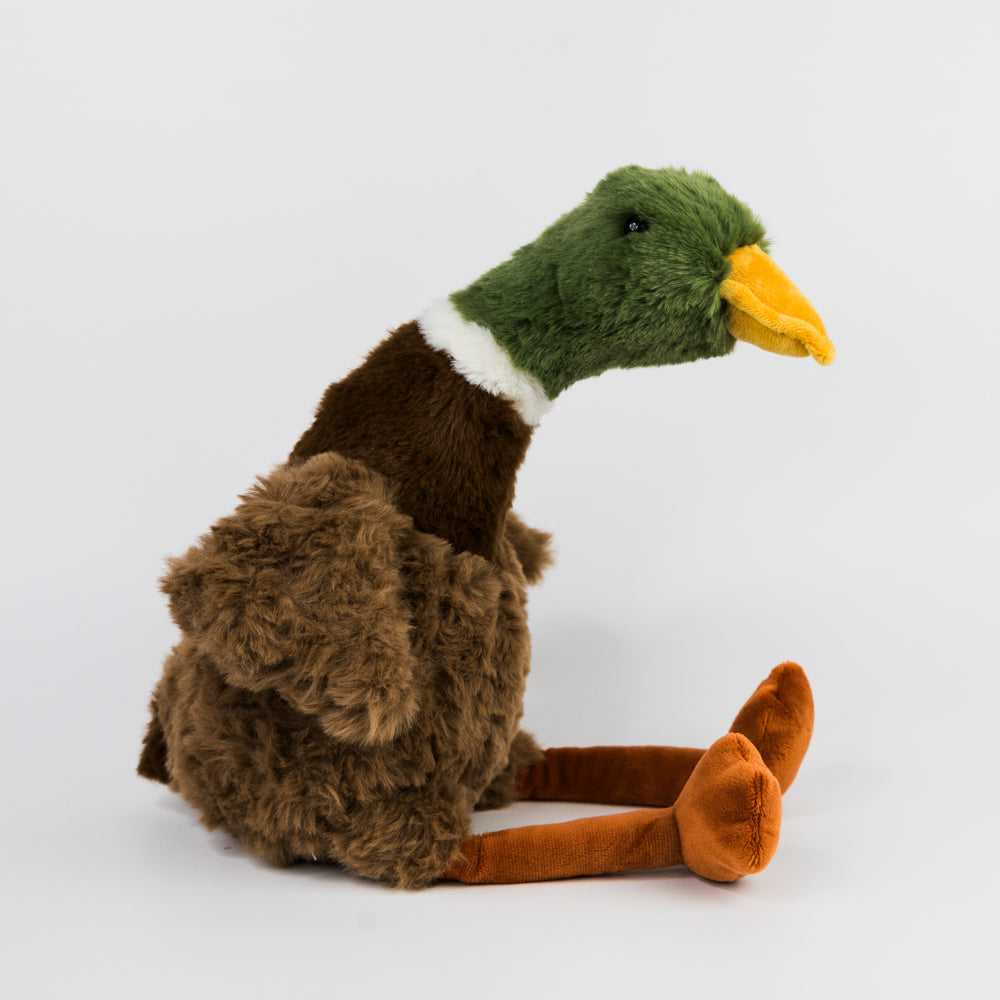 Plush toy resembling a duckwith a green head and brown body on a white background