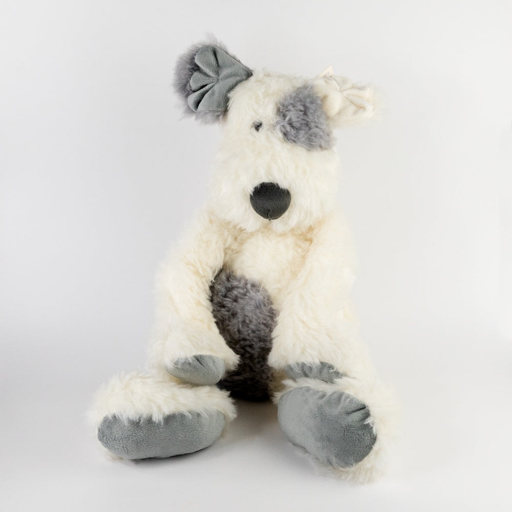 Plush toy dog with gray accents on a light gray background
