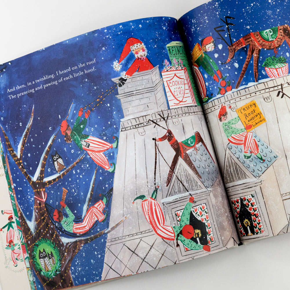 Illustrated book open to a page with Santa Claus on a rooftop and other festive illustrations.