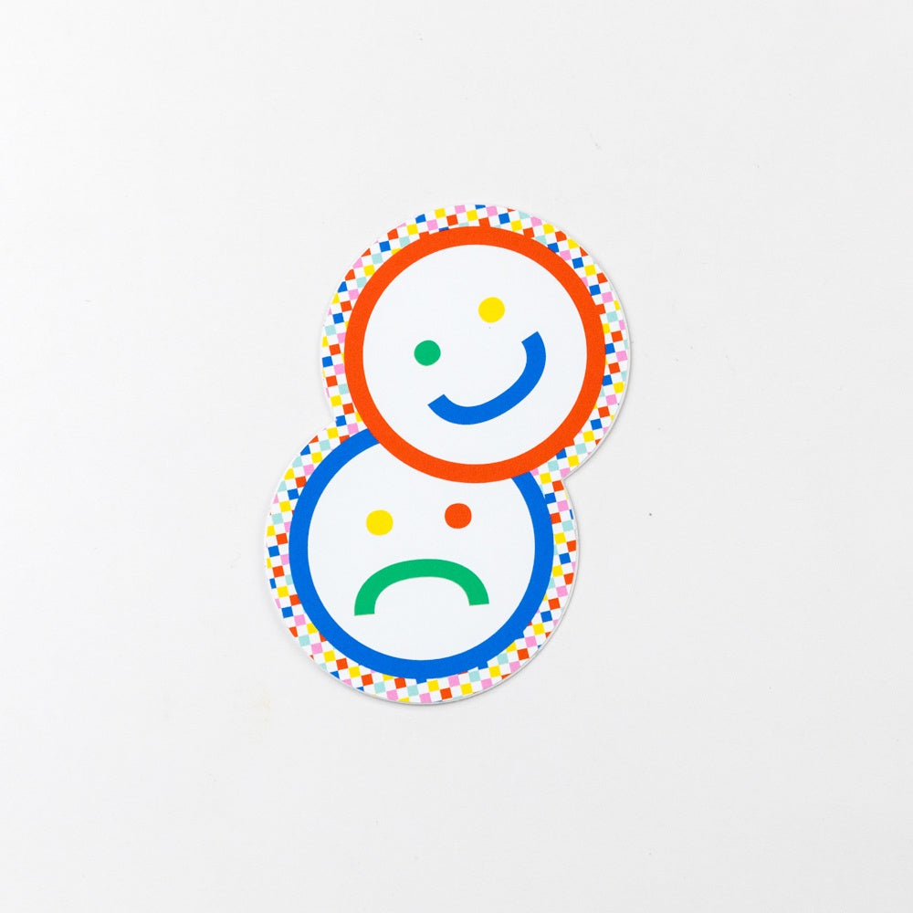 Two circular emoticons, one happy and one sad, with colorful dots on a white background.