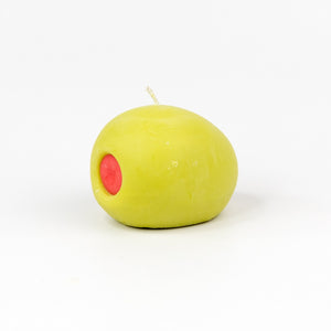 A green olive with red pimento shaped candle