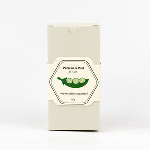 Product packaging of 'Peas in a Pod' candle on a white background