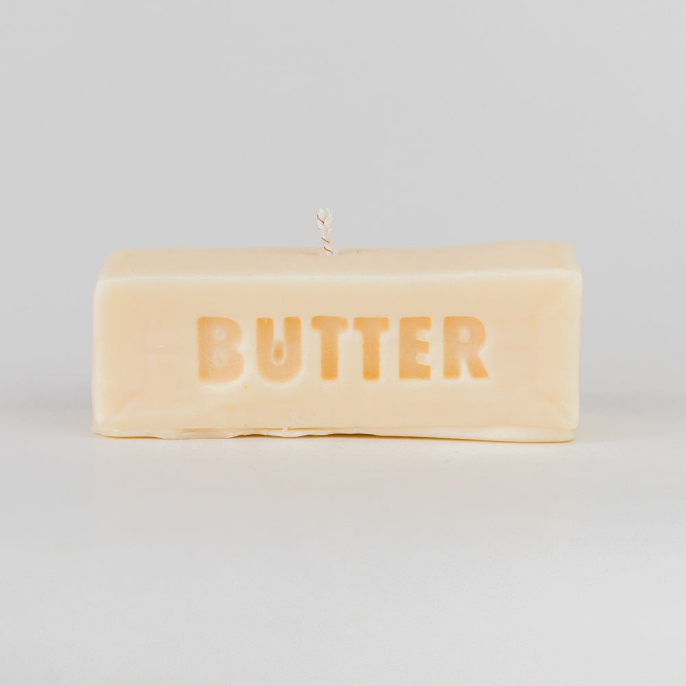 Rectangular candle with 'BUTTER' text on a light gray background