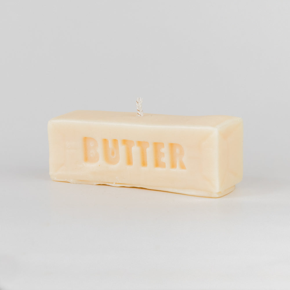 Rectangular candle with 'BUTTER' text on a light gray background