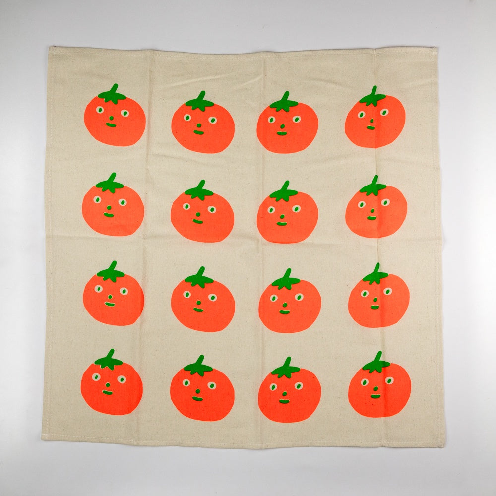 Beige fabric with red tomatoes with faces printed on a white background