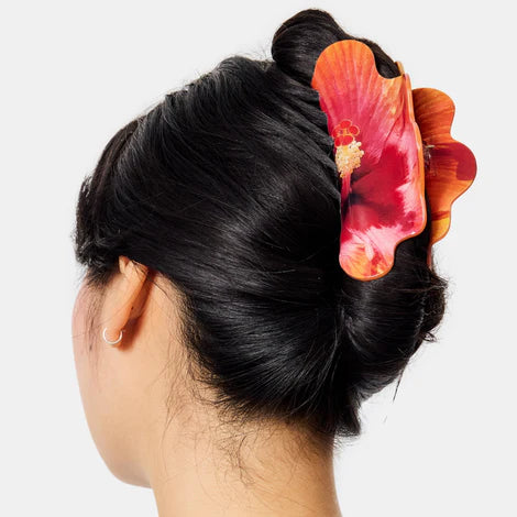 Hair claw with a photo-realistic hibiscus pattern on a white background
