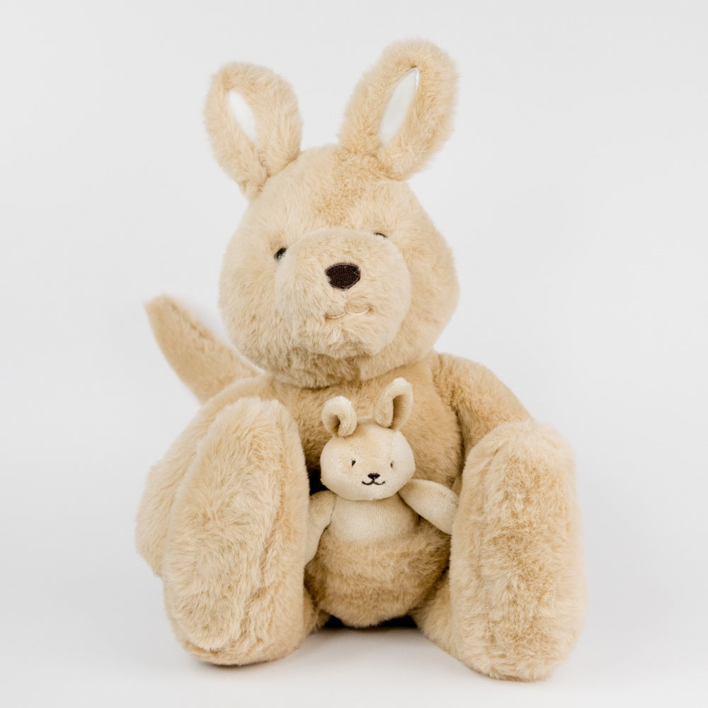 Beige plush kangaroo holding a smaller beige plush kangaroo in its pouch on a white background