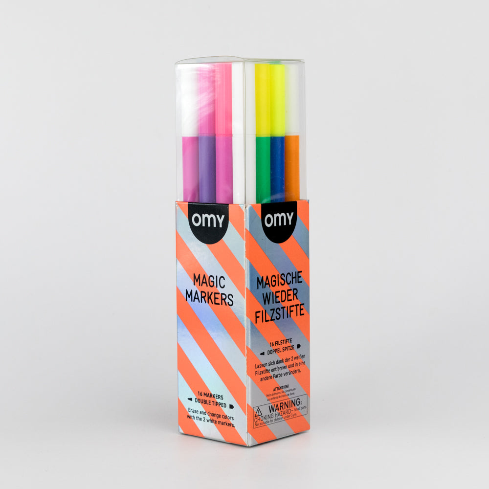 Box of OMY Magic Markers with colorful markers inside on a light gray background