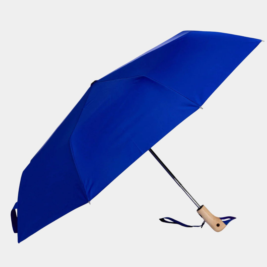 Blue umbrella with a wooden handle on a light gray background