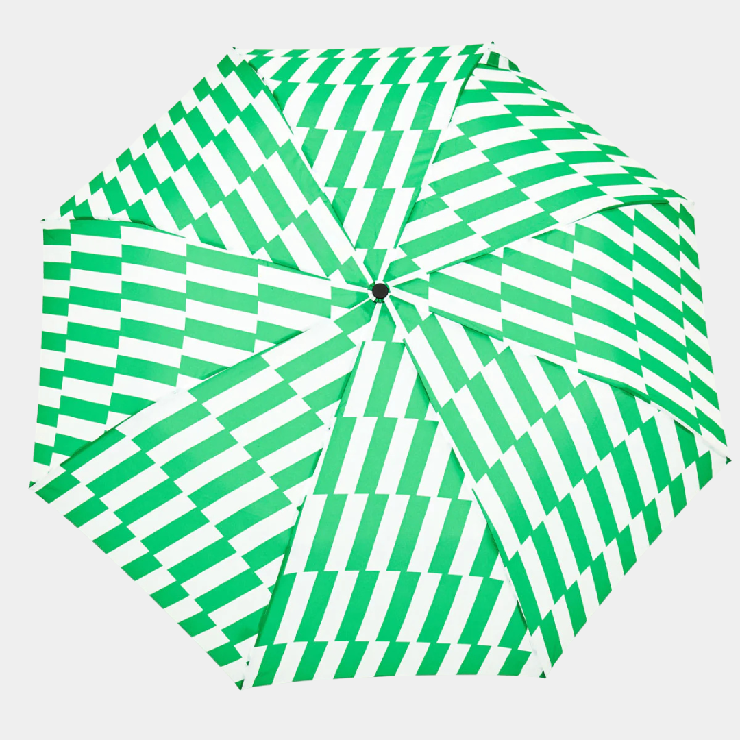 Green and white striped umbrella with wooden handle on a light gray background