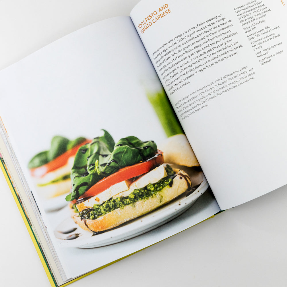 Open cookbook showing a recipe for a sandwich with spinach and tomato