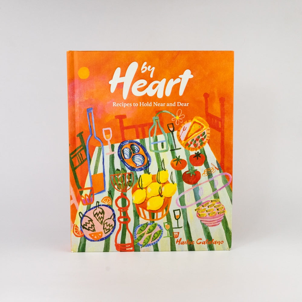 Book titled 'By Heart' with colorful illustrations on an orange background