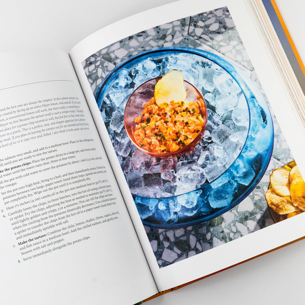 Open book with a photograph of a dish on ice, likely from a cookbook.