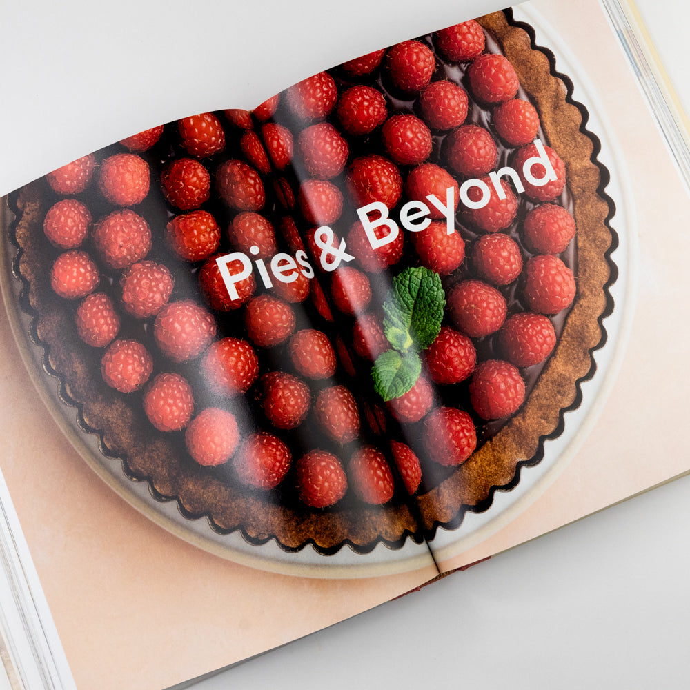 Open book with Berry pie with 'Pies & Beyond' text on a light background