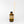 Brown bottle with black cap and wooden sticks on a white background
