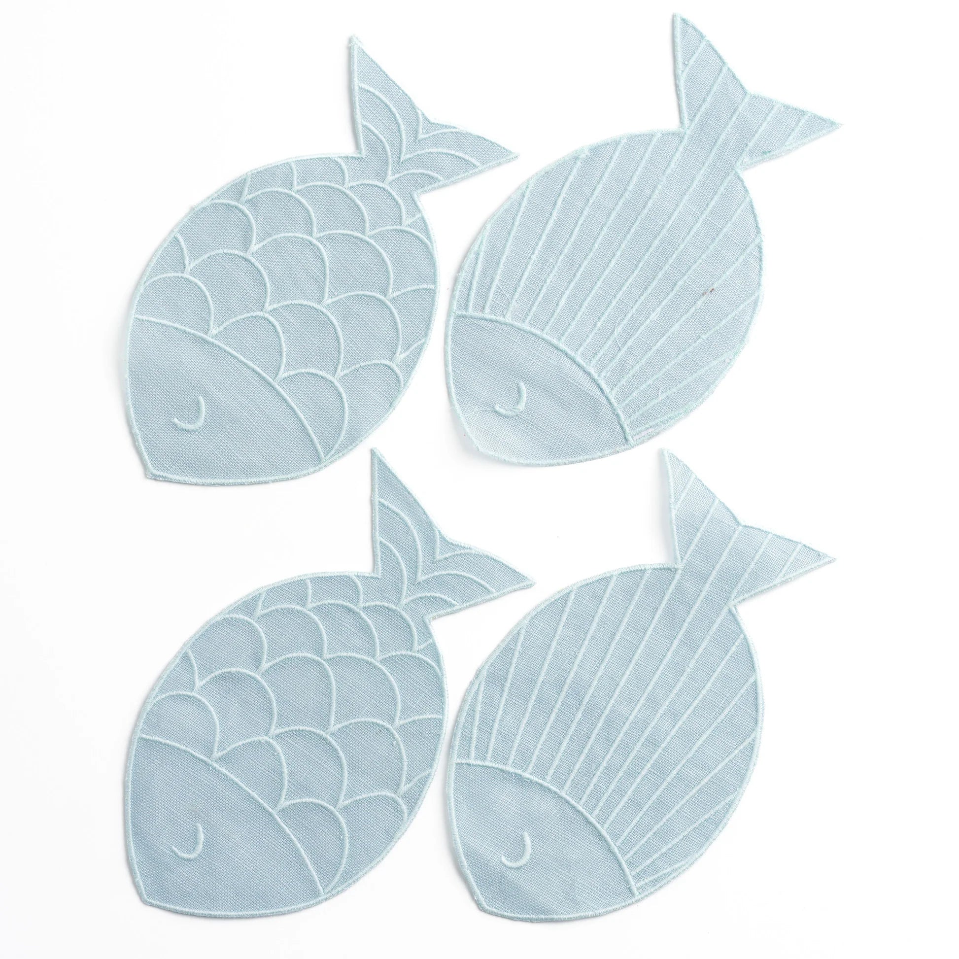 Four light blue fish-shaped napkins on a white background