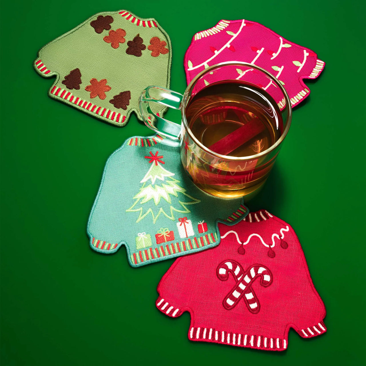 Pack of cocktail napkins with Christmas-themed ugly sweaters on a white background
